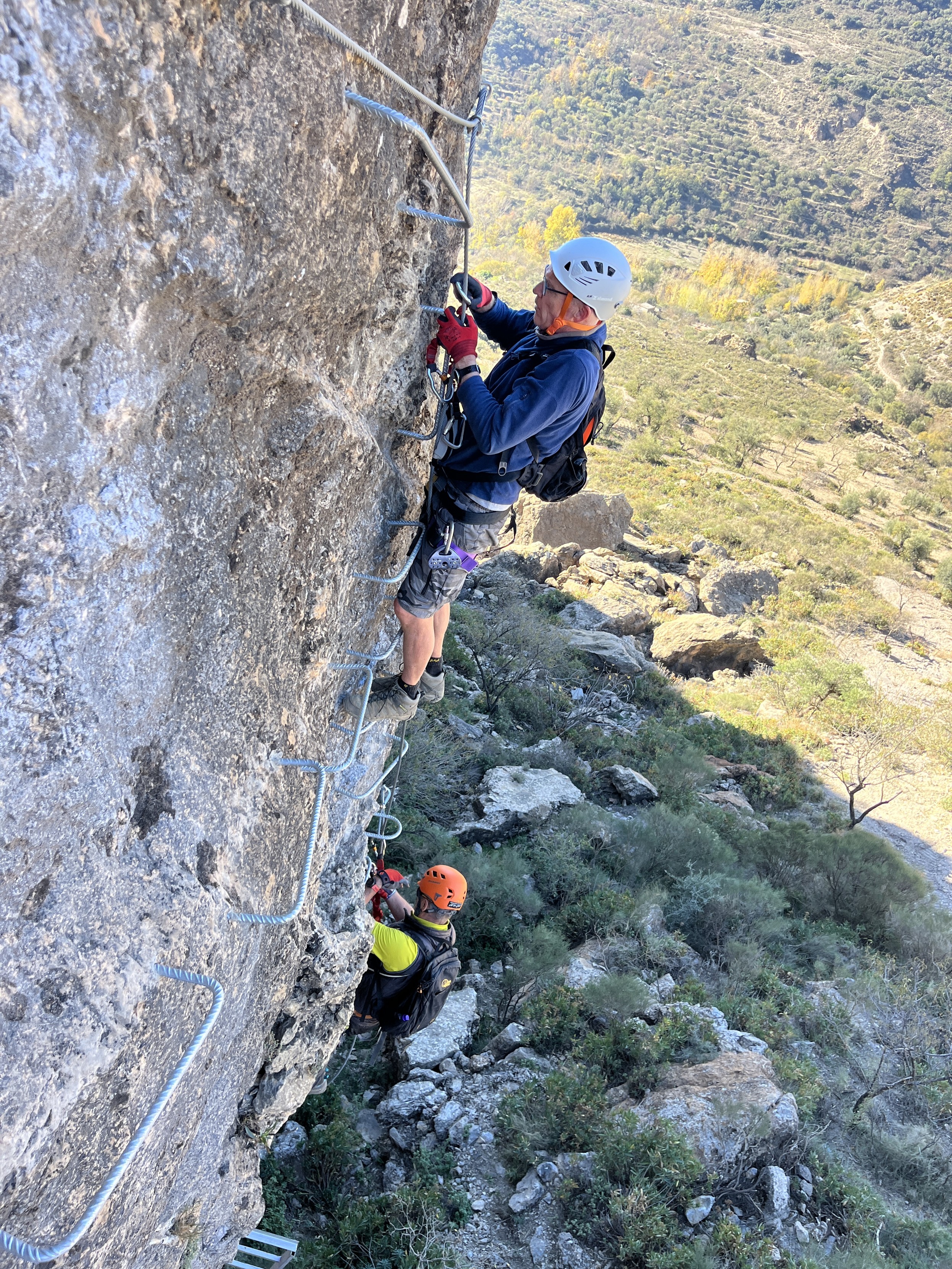 2 people practice via ferratas in Andalucia. Steep ladders, cables and zip lines