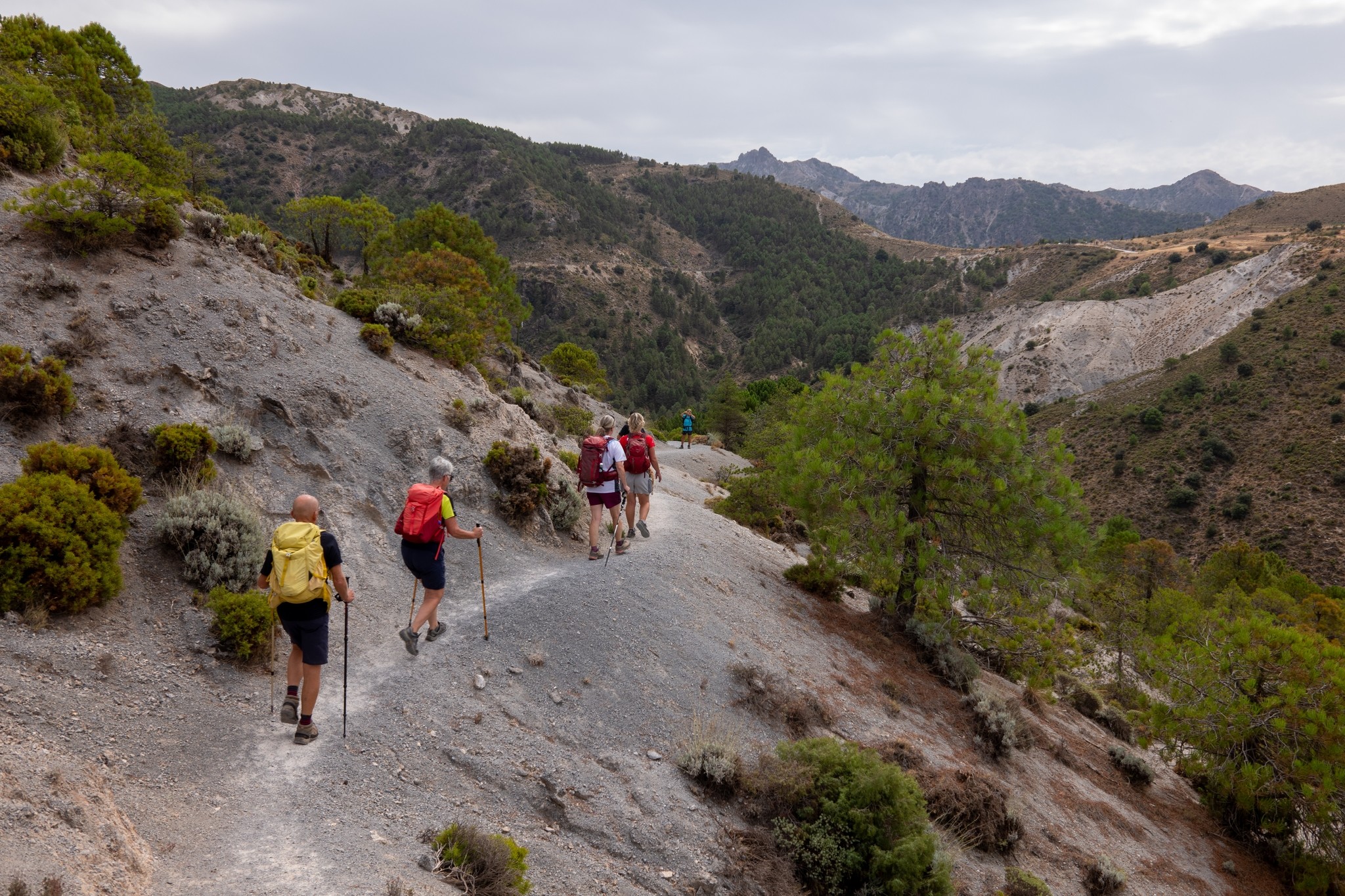 Hikers path along a narrow arid trail. Ahead lies Collado Sevilla where this route starts and finishes