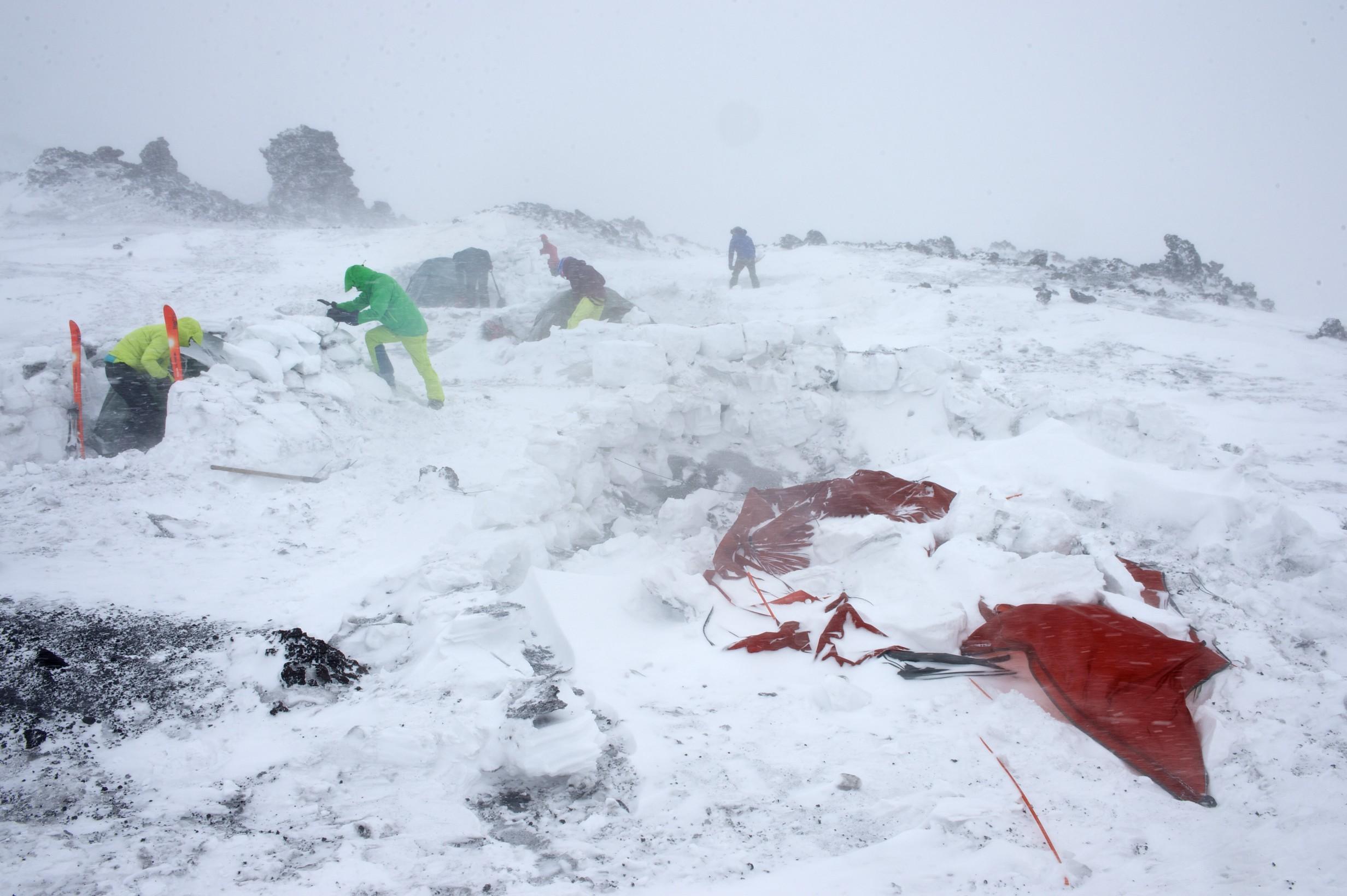 Base camp destroyed by high winds containing volcanic rocks