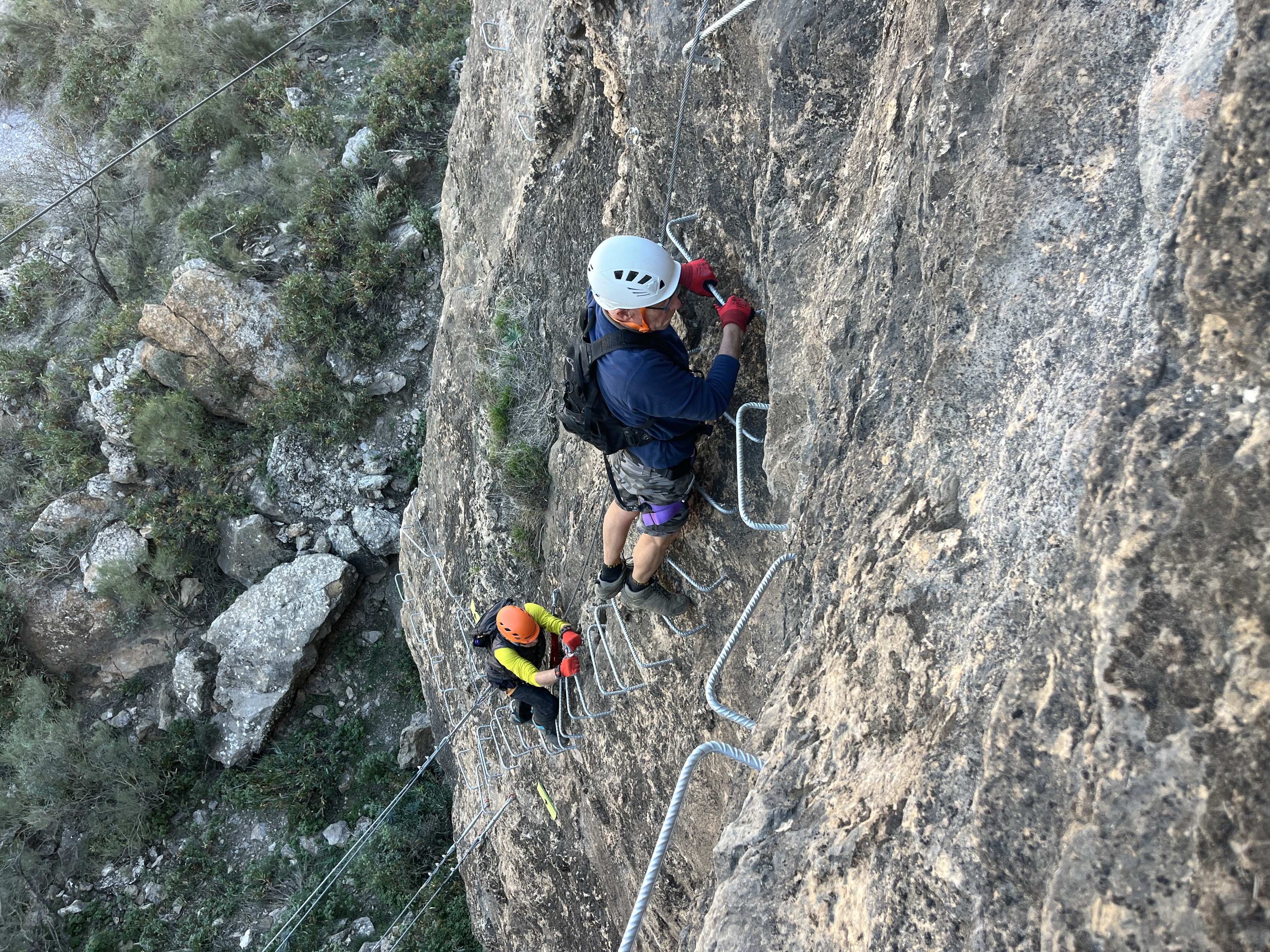 2 people practice via ferratas in Andalucia. Steep ladders, cables and zip lines