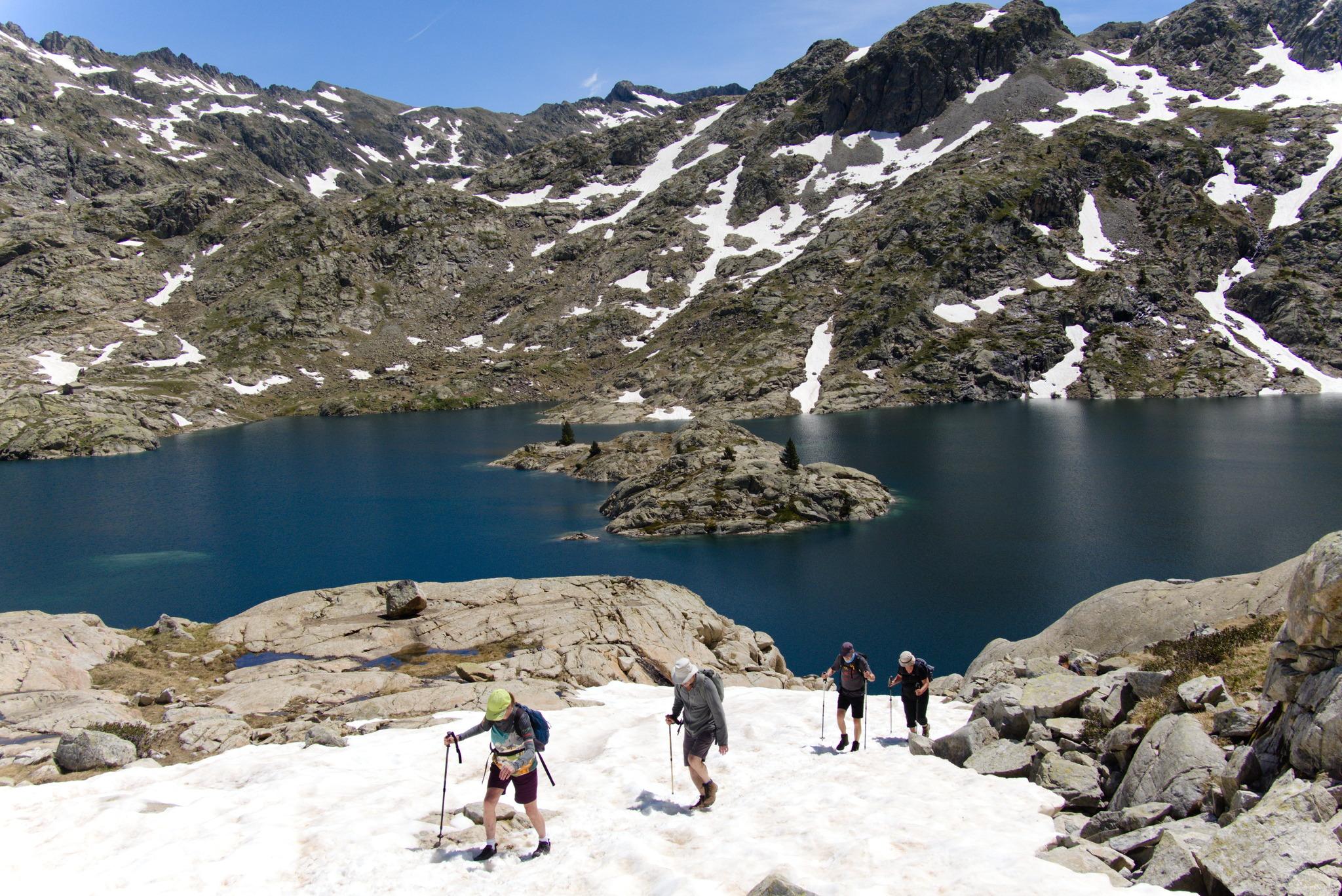 Crossing a snowfield above the lake. The french border beyond