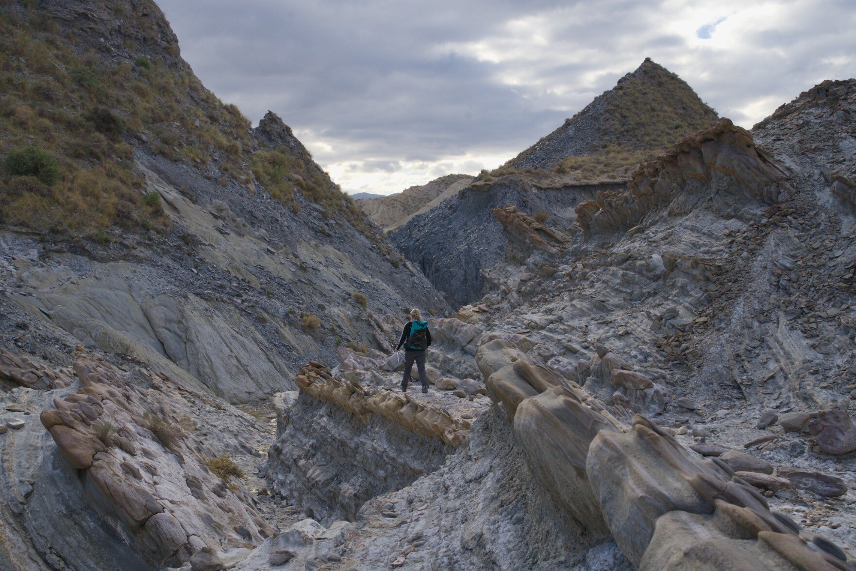 Person stood in valley with strange and unusual rock formations. Tabernas, desert badlands, Almeria, Spain