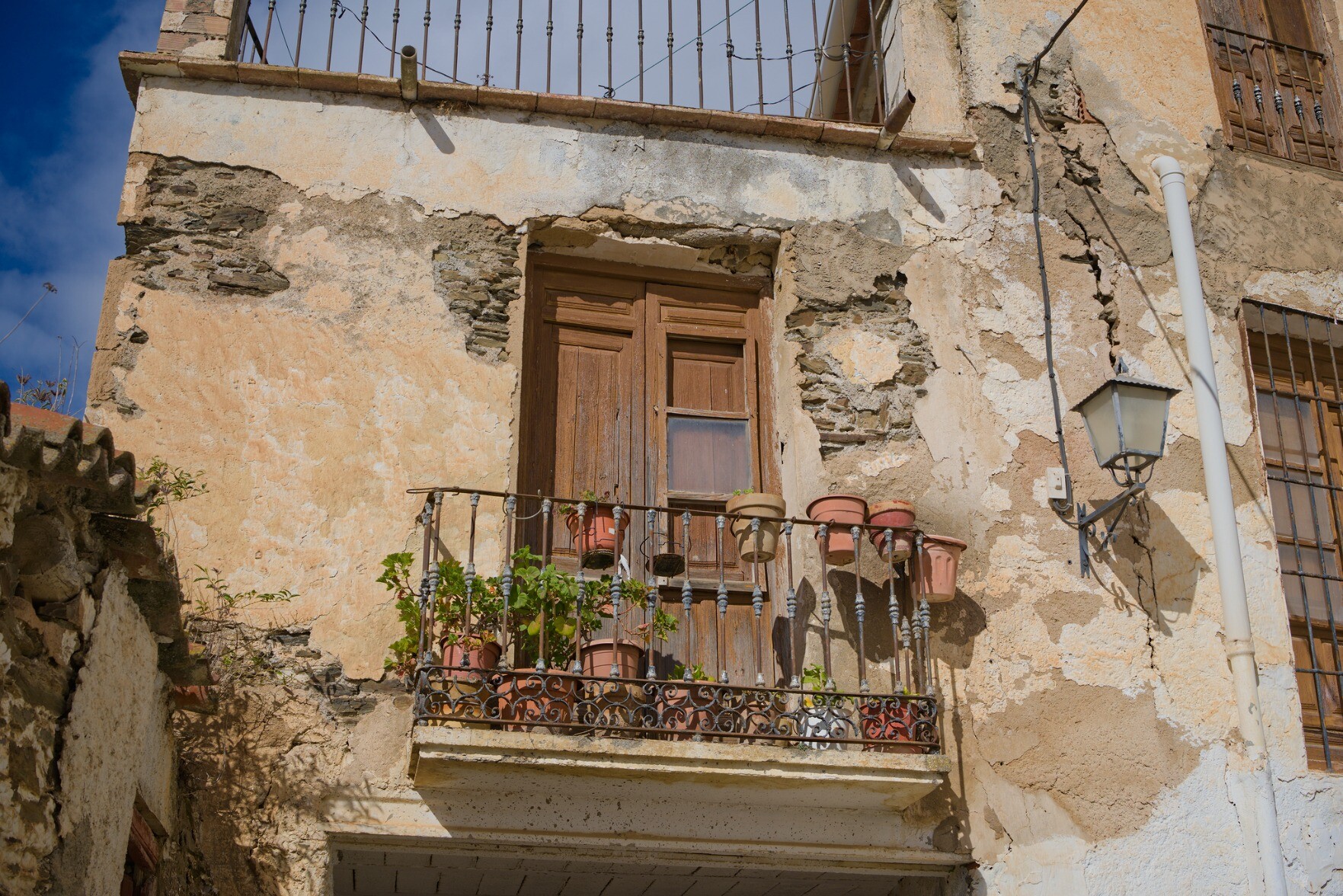 Front of an old spanish village house that needs a bit of love and care