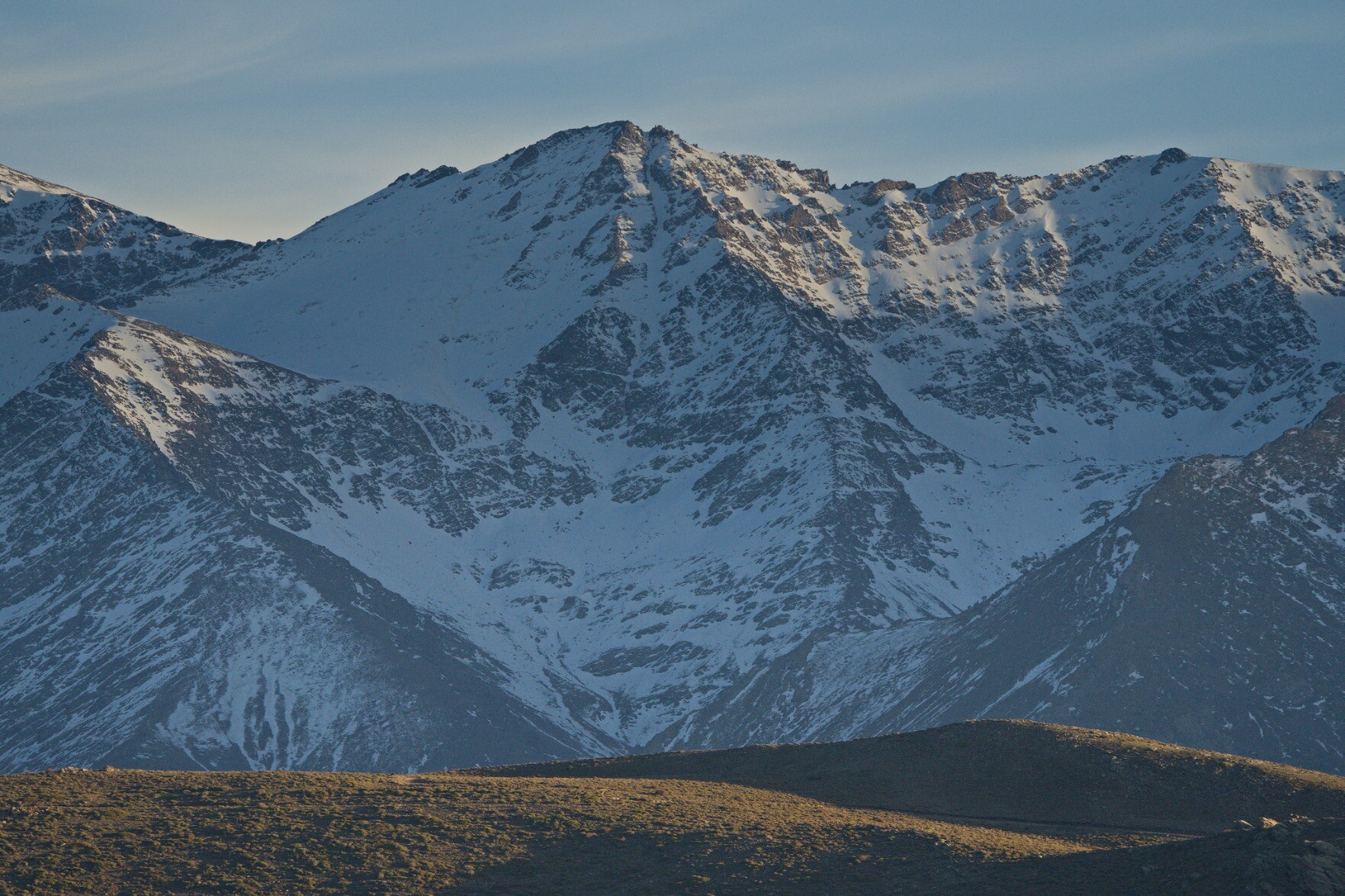 The peak of Puntal de la Caldera, a steep northern mountain face covered in snow