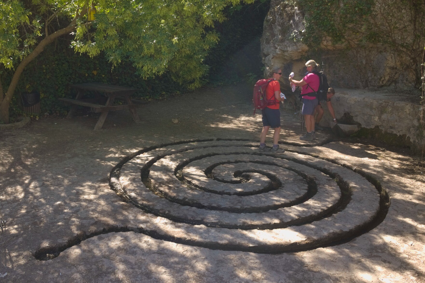 Water drops from a spring into a circular system of water channels that creates cool air