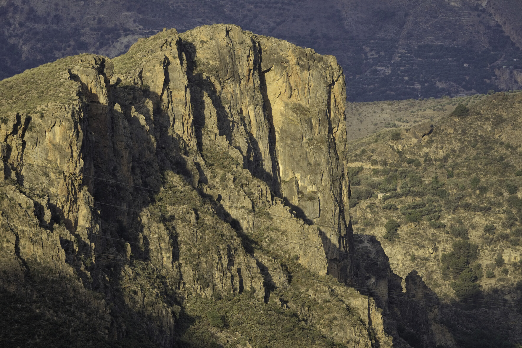 To the left, some high cliffs bathed in morning sunlight whilst their gullies remain hidden in shadow