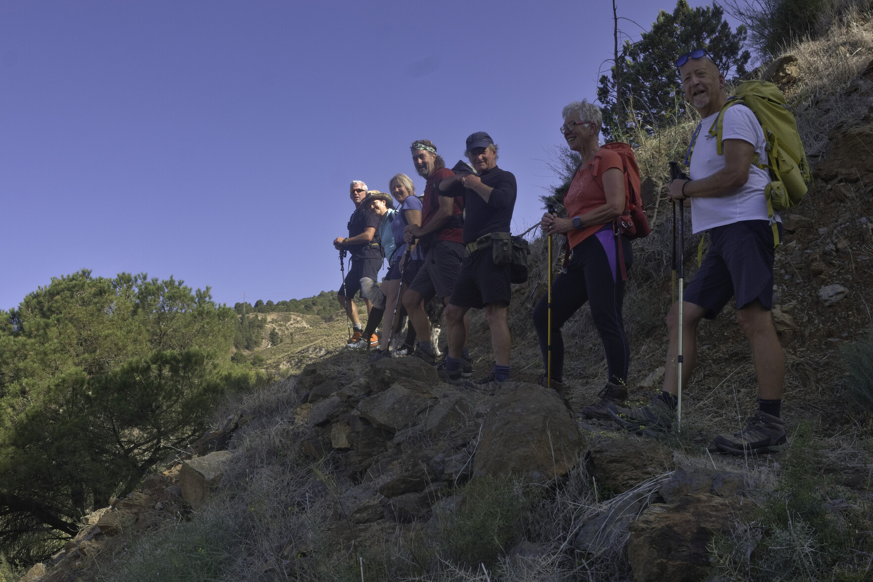 A group of hikers admire the view. Blue sky above