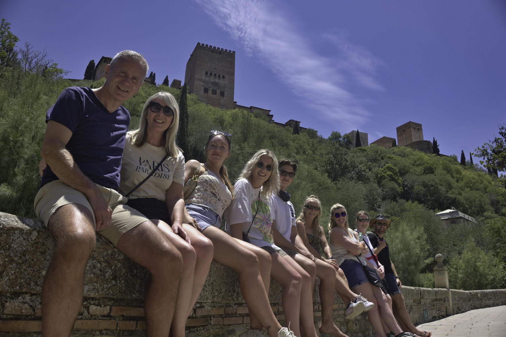 My hiking group sat on a wall beneath the Alhambra Palace