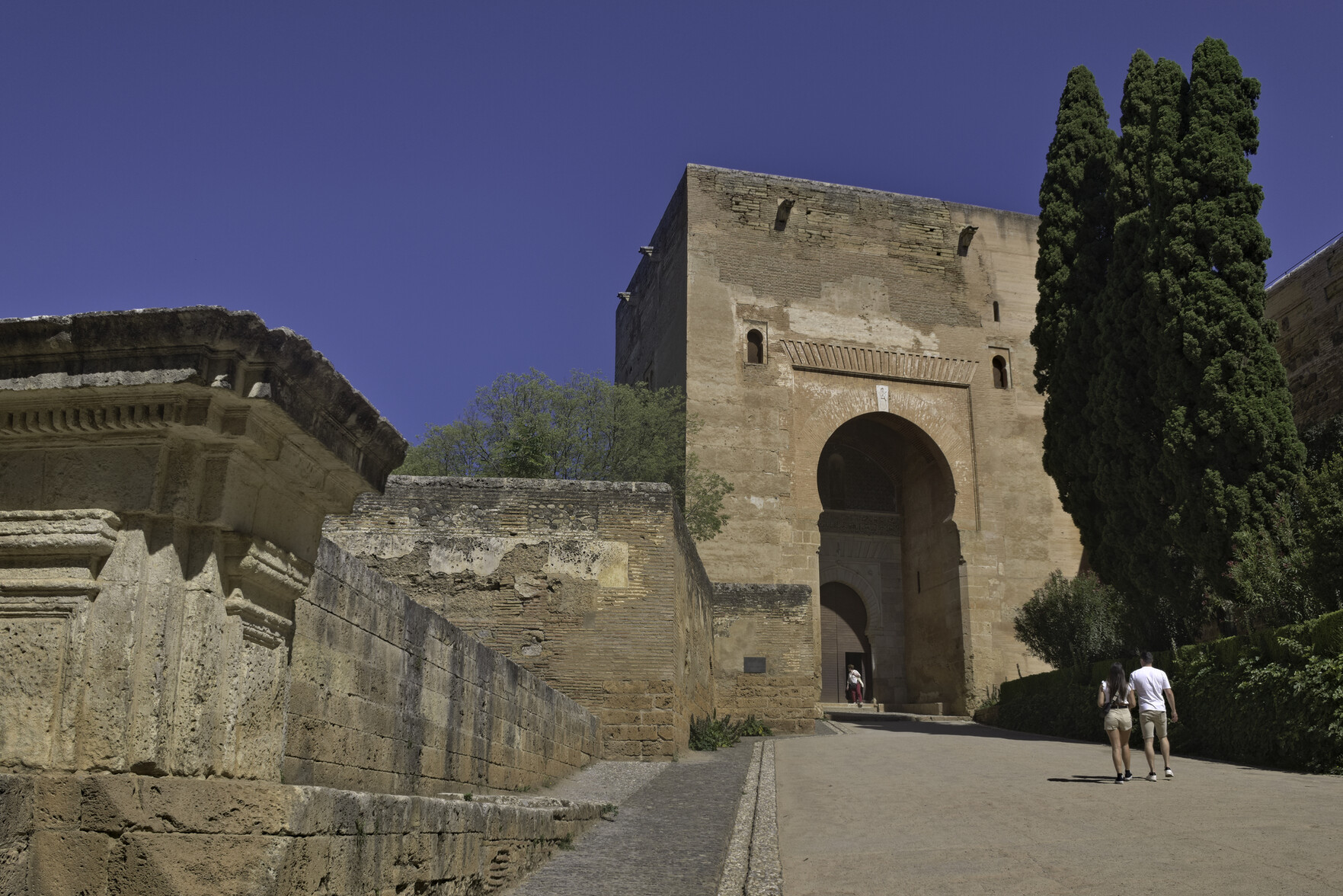 The "Puerta de la Justicia" entrance to the palace ground. This has a large imposing gate with a horseshoe arch & entrance leading to the Palace of Carlos Quinto.