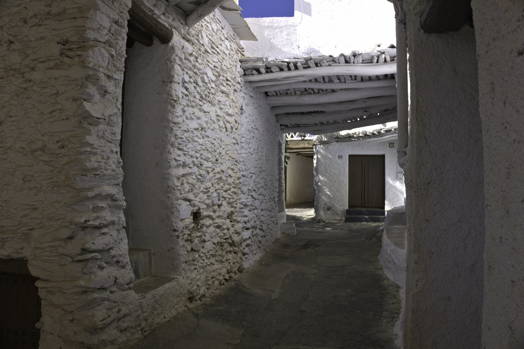 A narrow street in Capilerilla with traditional "tinao" roofing