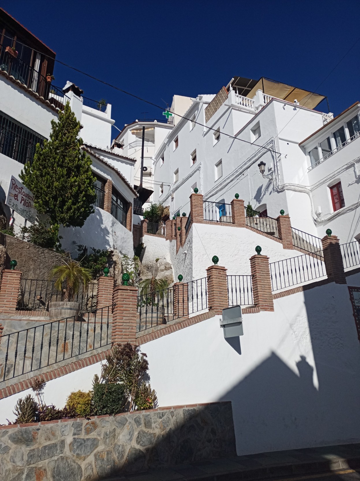 Whitewashed houses climb a steep hillside in Andalucía, Spain
