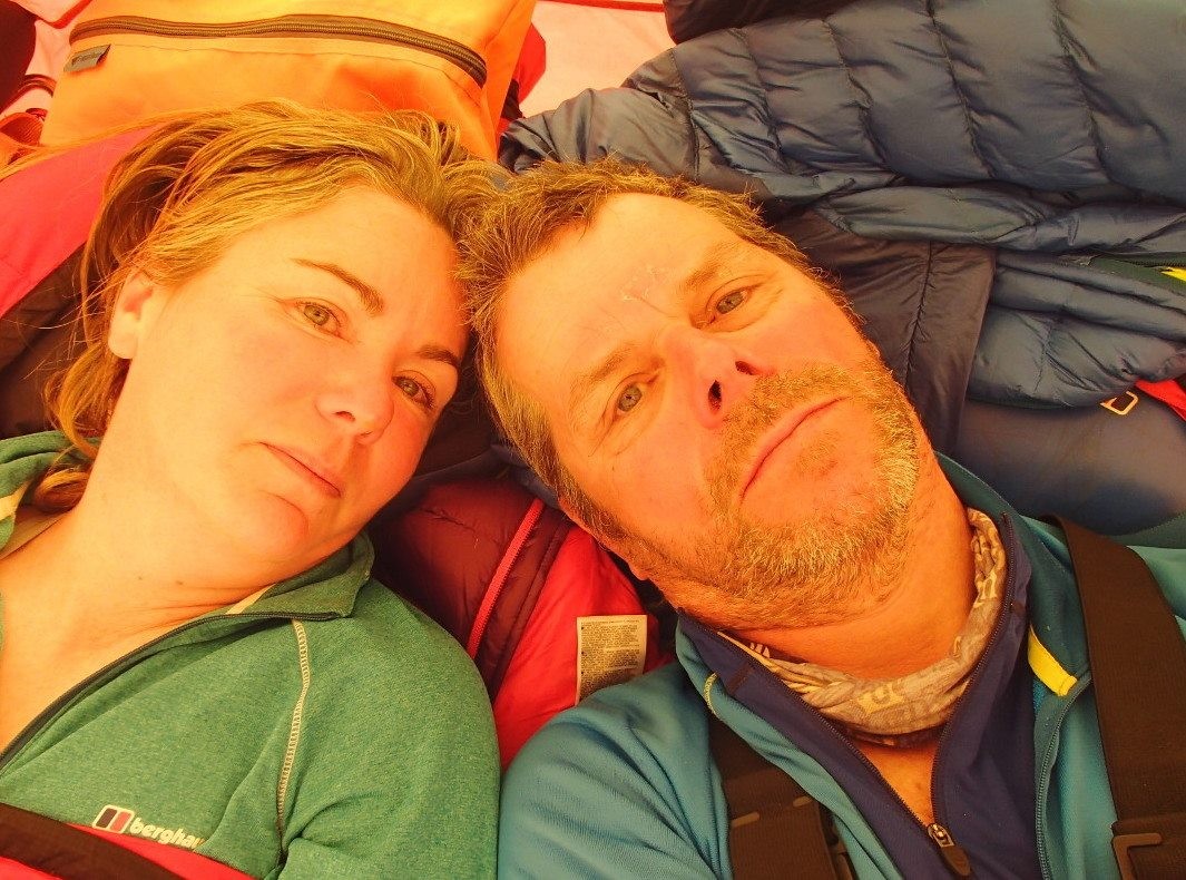 Too people lie head to head in a tent whilst a blizzard rages outside