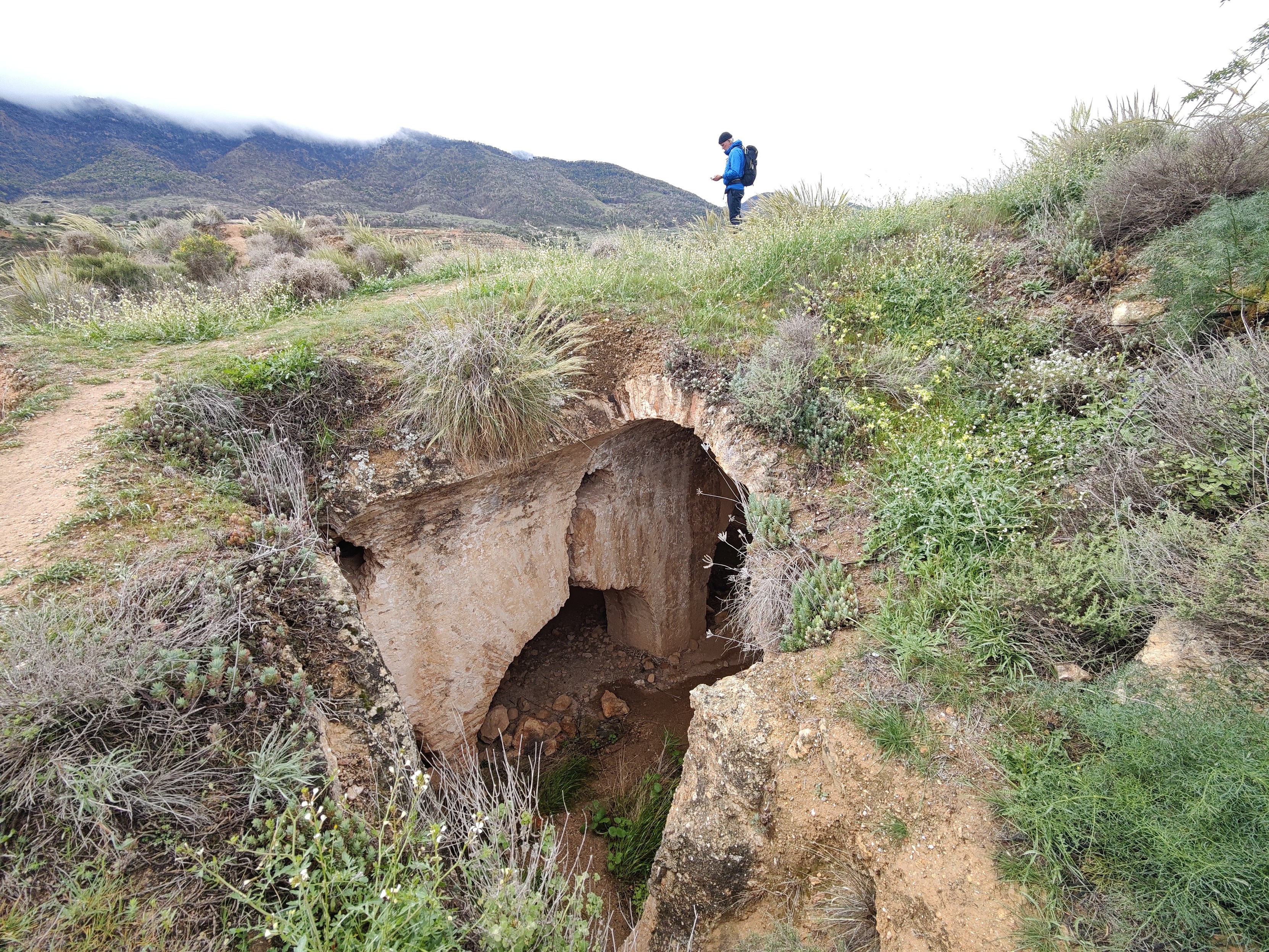 A person stands above some ancient ruins of an arab castle