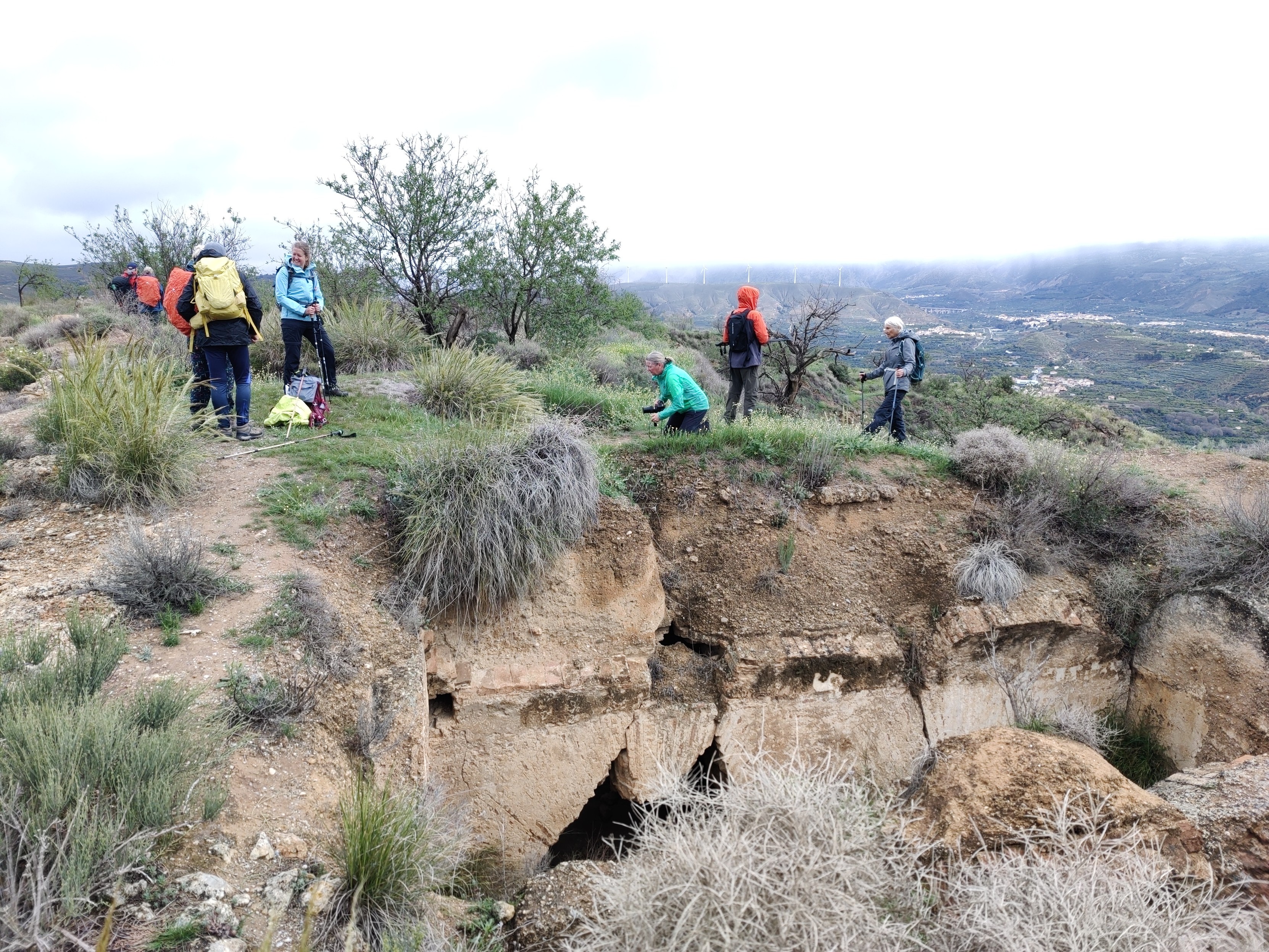 Some people stand above some ancient castle ruins built by the moors