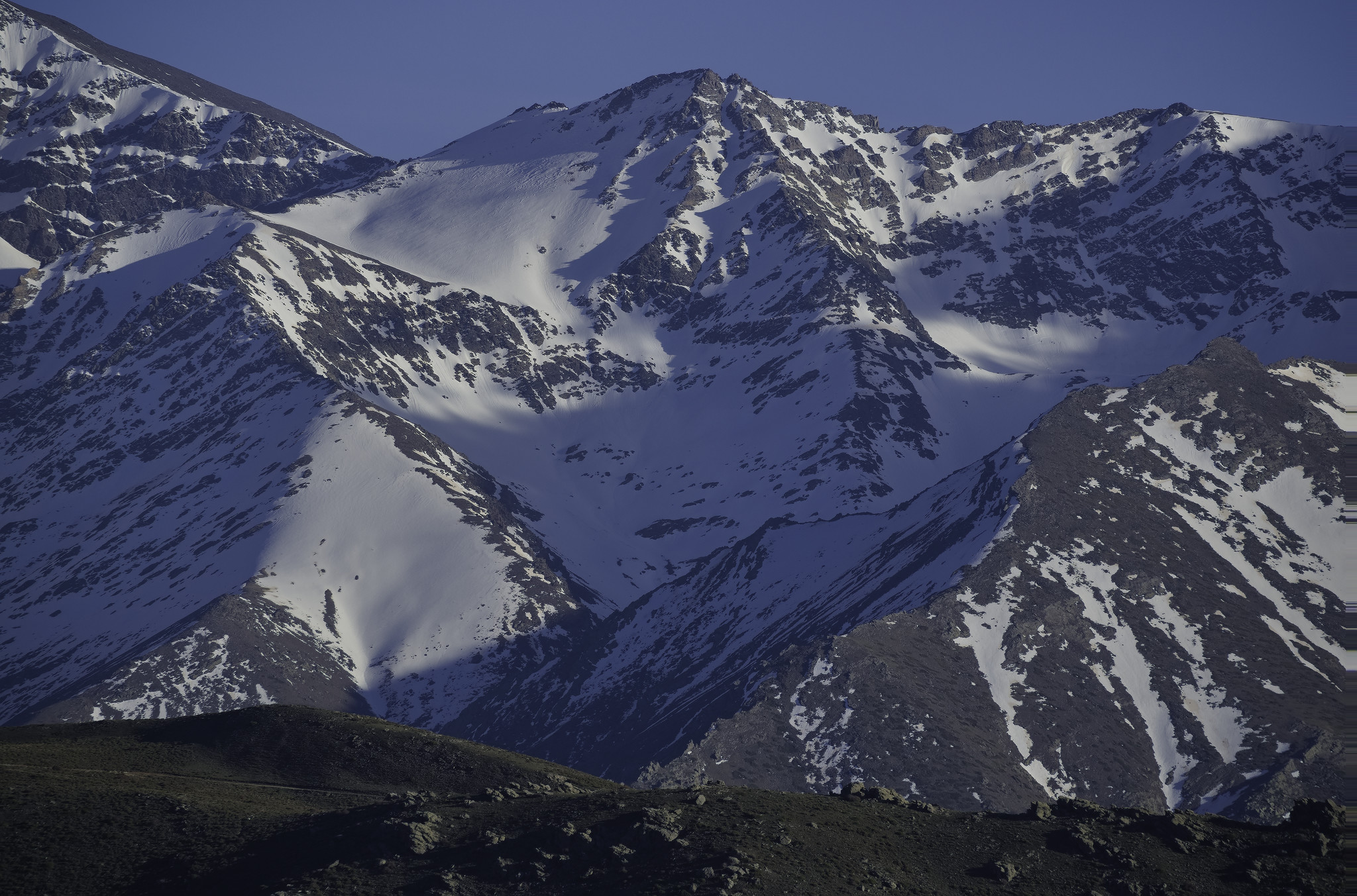 One of my favorite mountains, the Puntal de la Caldera 3223m. No so easy to ascend by any of it's slopes but the southern approach is easiest. 

A twisted network of shadowed valleys leads to some sunlit upper snow slopes