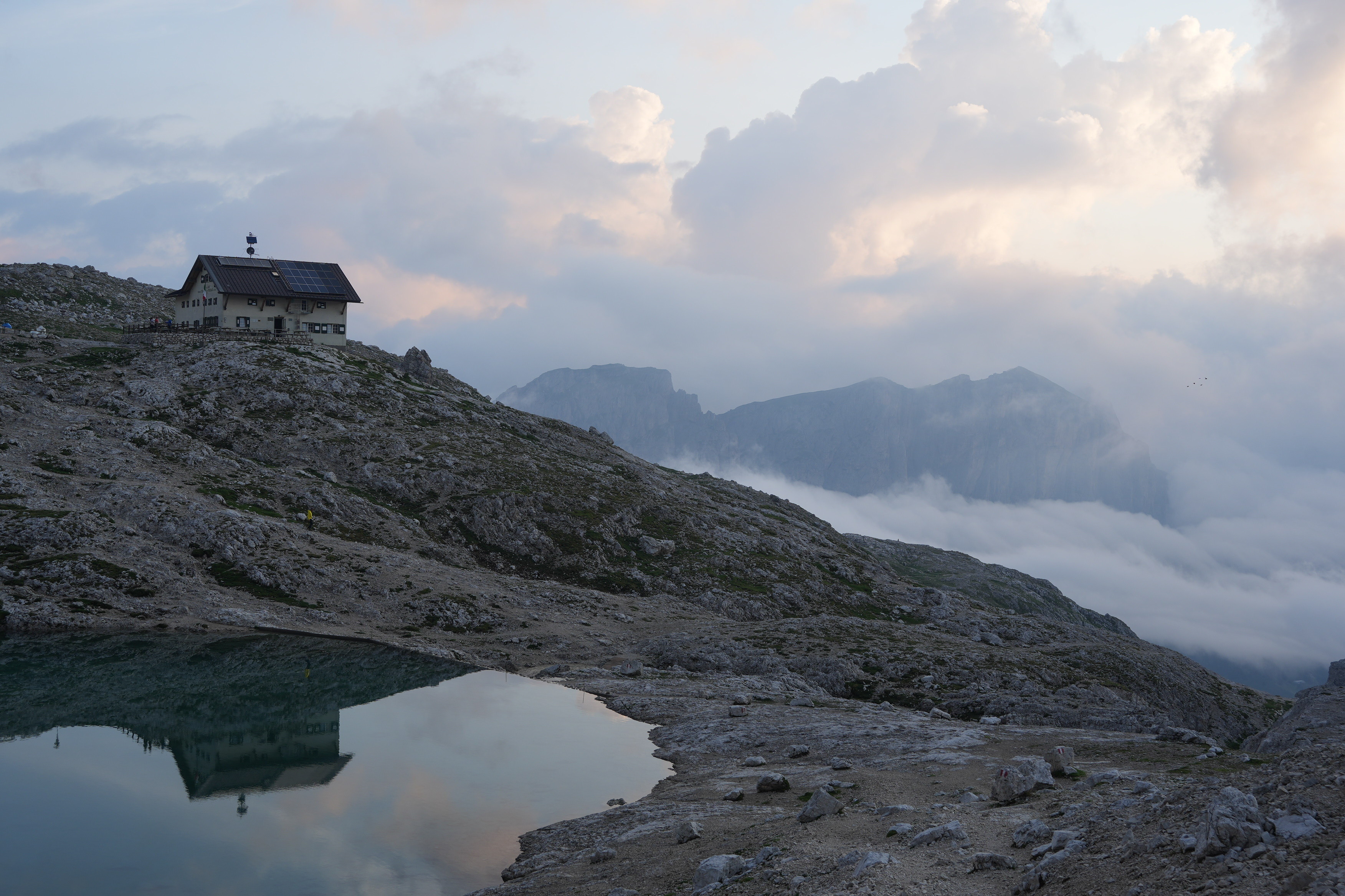 The Rifugio Pisciadu reflected in the lake of the same name