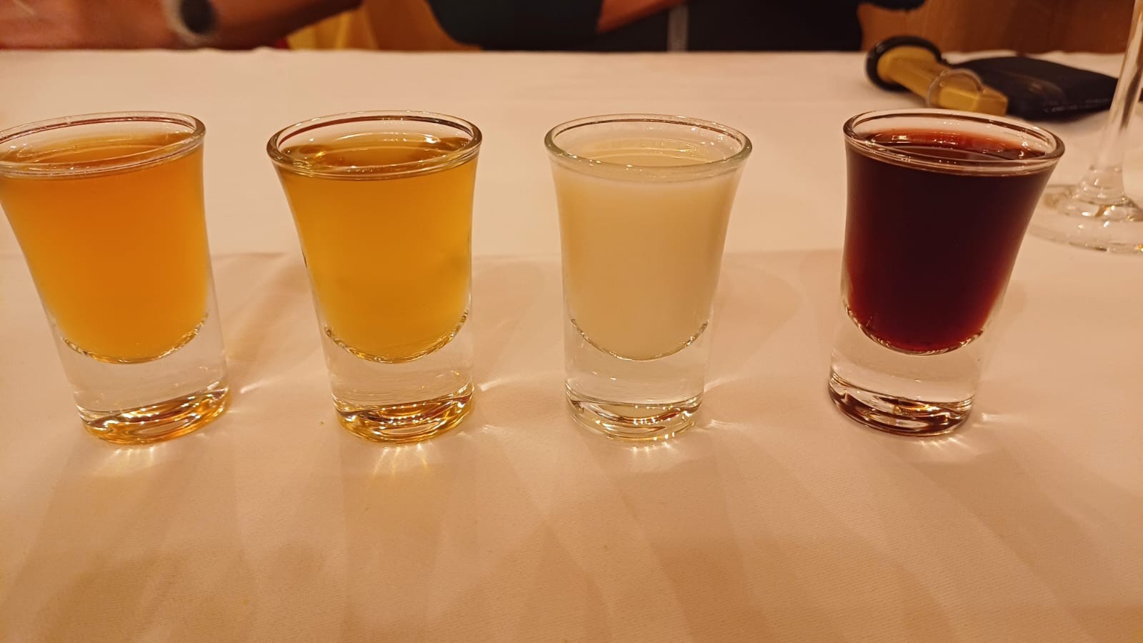 4 small glasses of favoured grappas. Pine resin, honey, blueberry and herb