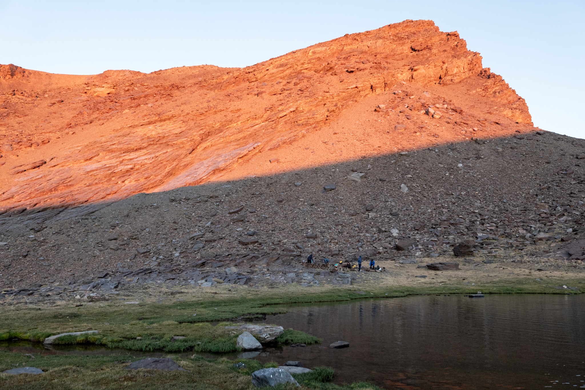 Our camp situated below Mulhacen. highest mountain in mainland Spain. Morning sunlight hits the top of the mountain. Our camp remains in shadow as is the adjacent lake.