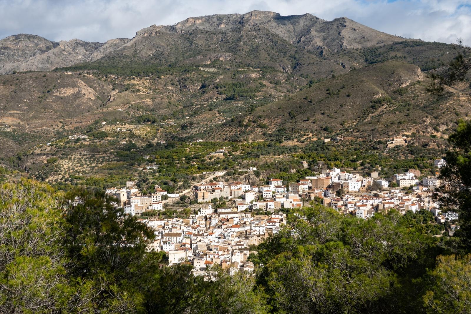 The village of Guajar-Faraguit in the los Guajares Valley. A mountain rises above the town