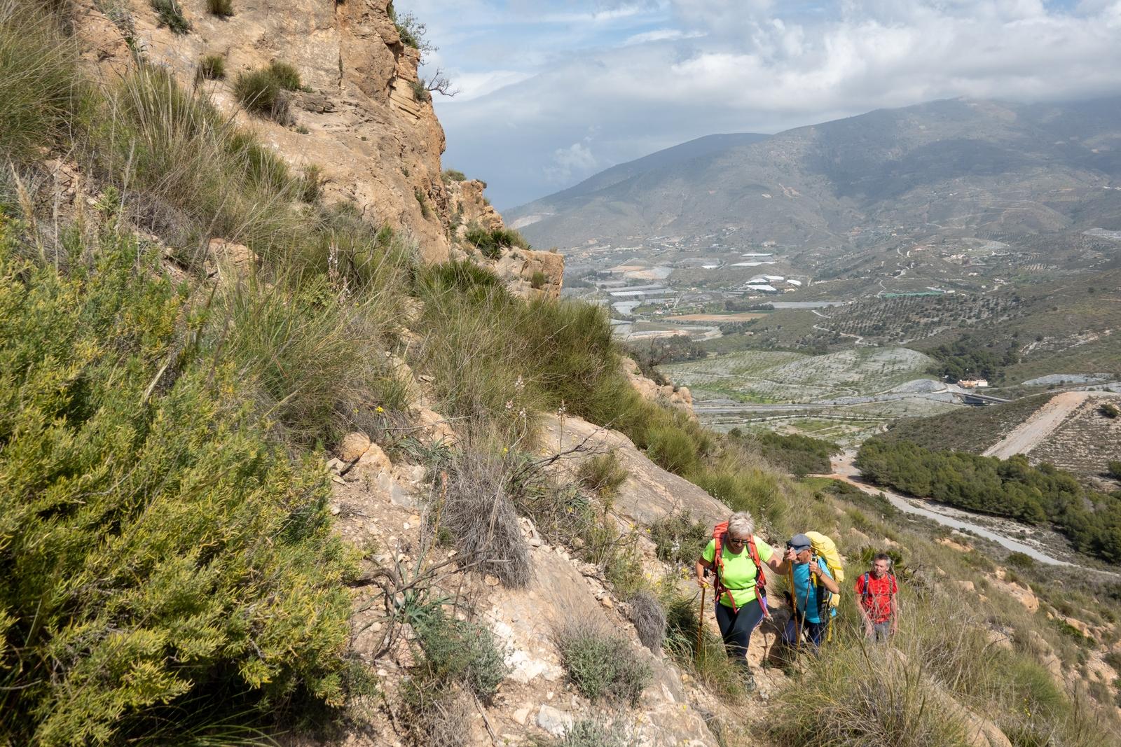 The final ascent to the summit of Cerro Gordo involves a traverse along a narrow path below the summit crags