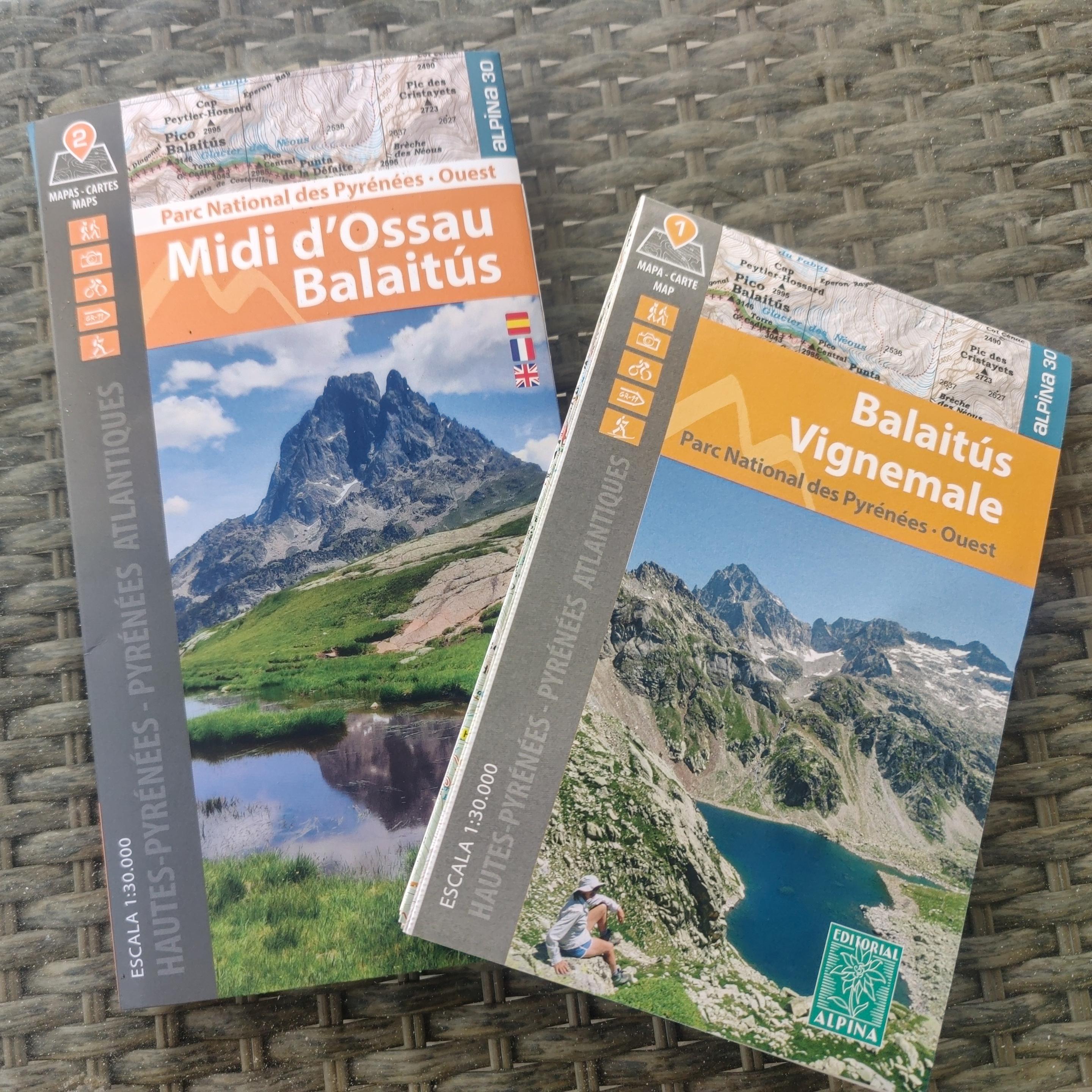 Paper maps of some mountain areas of the Pyrenees laid out on a table