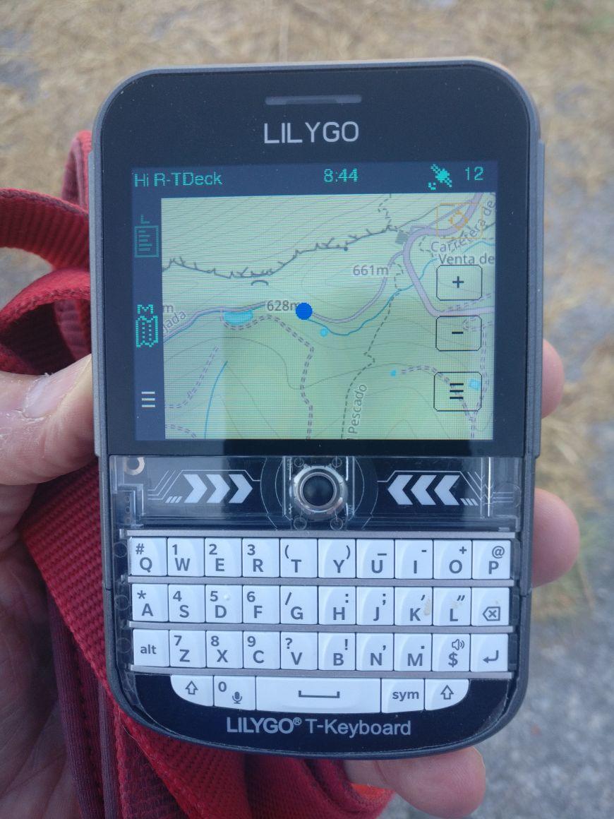 A small Lilygo T-Deck Plus LoRa radio with keyboard, showing the map screen. A blue dot indicates where the author is located on the map. 
