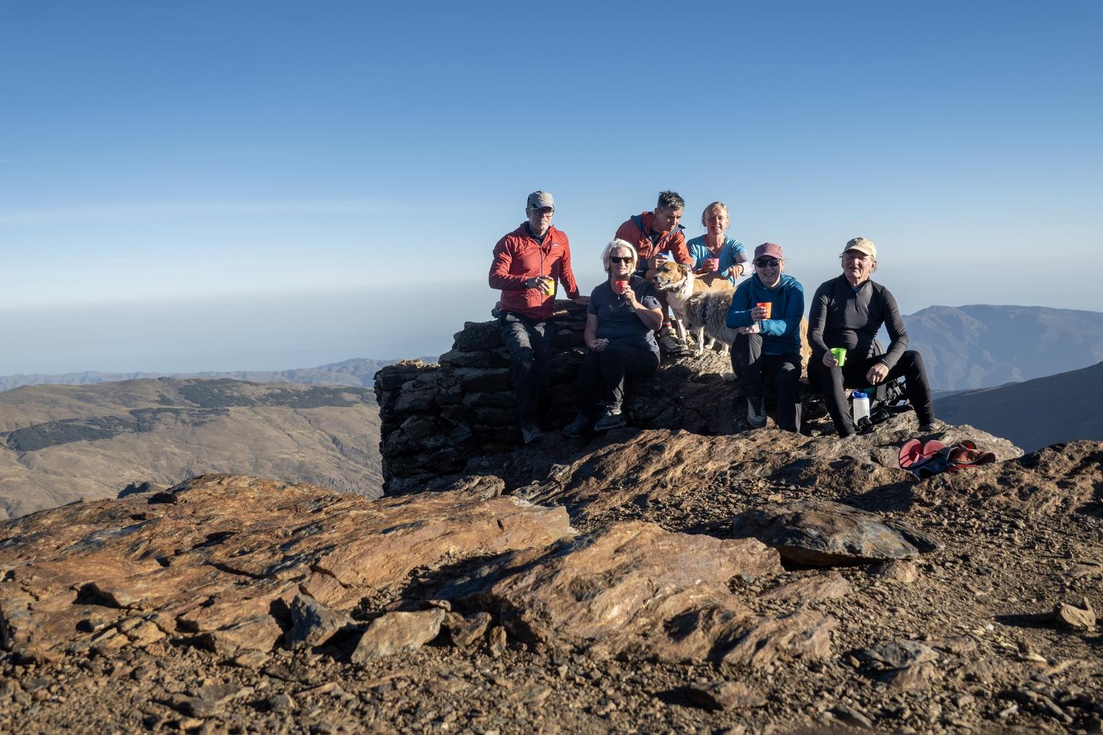 The group at the summit of Loma Pua enjoying a after dinner vino