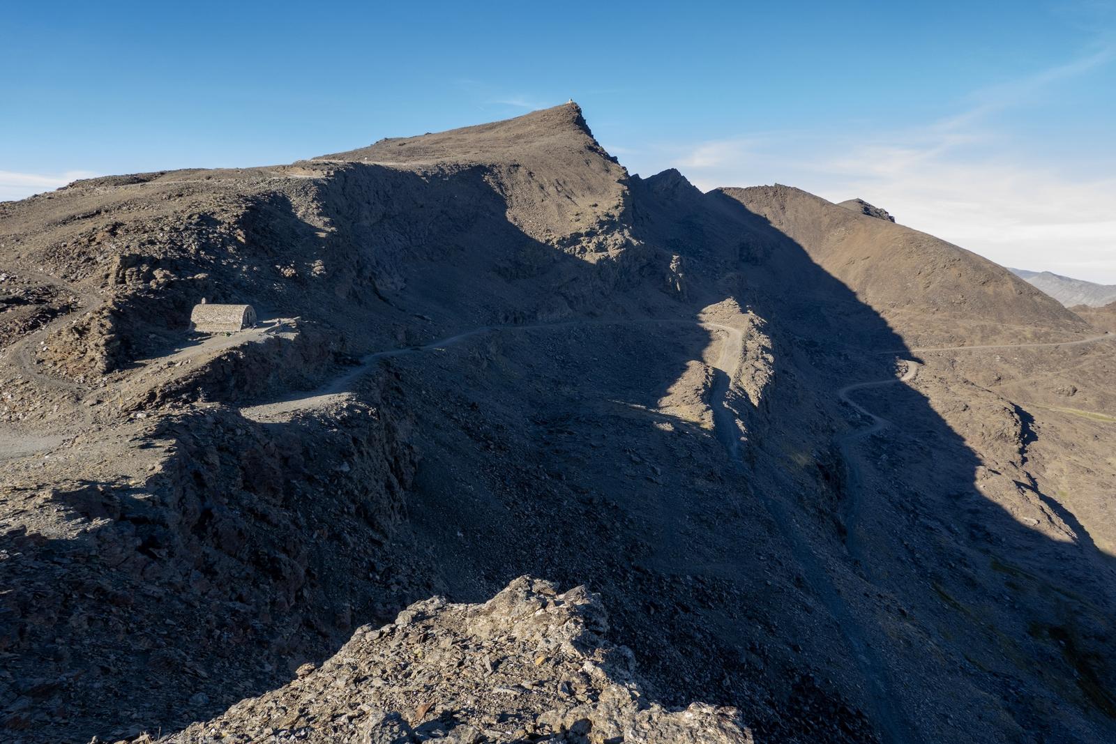 The view south to Veleta 3394m and the unmanned Refugio de Carihuela and col of the same name