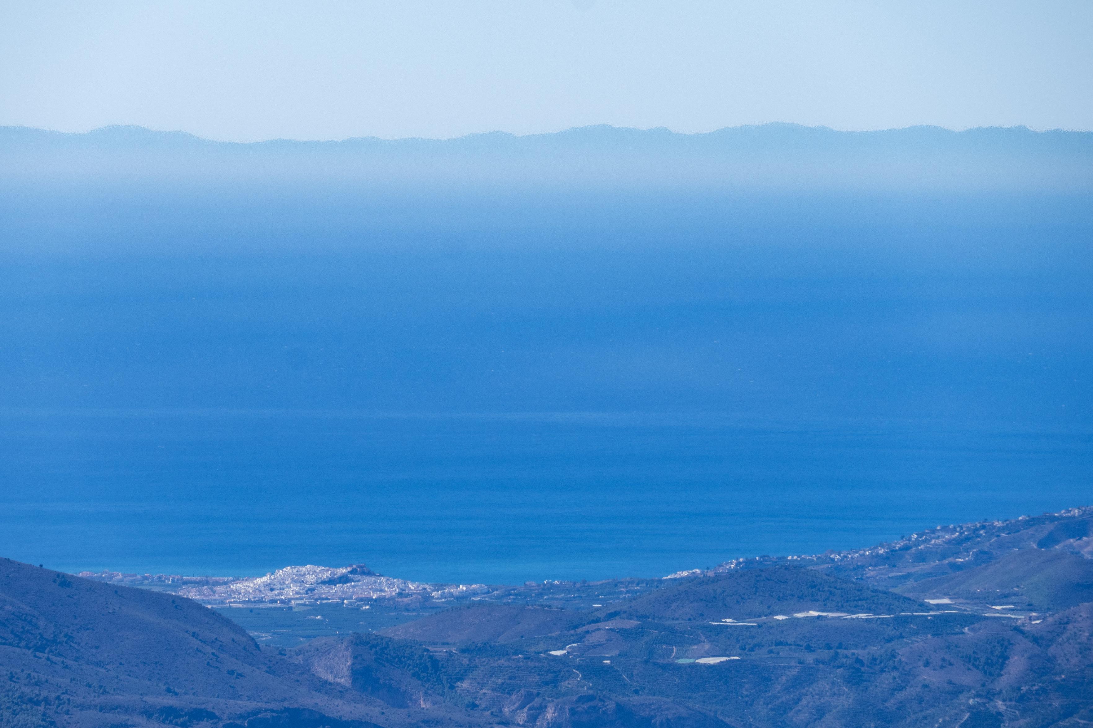 View from the summit of las Alegas 2700m looking south over the white town of Salobreña, over the blue Mediterranean Sea to Al Hoceima and hills in Morocco.