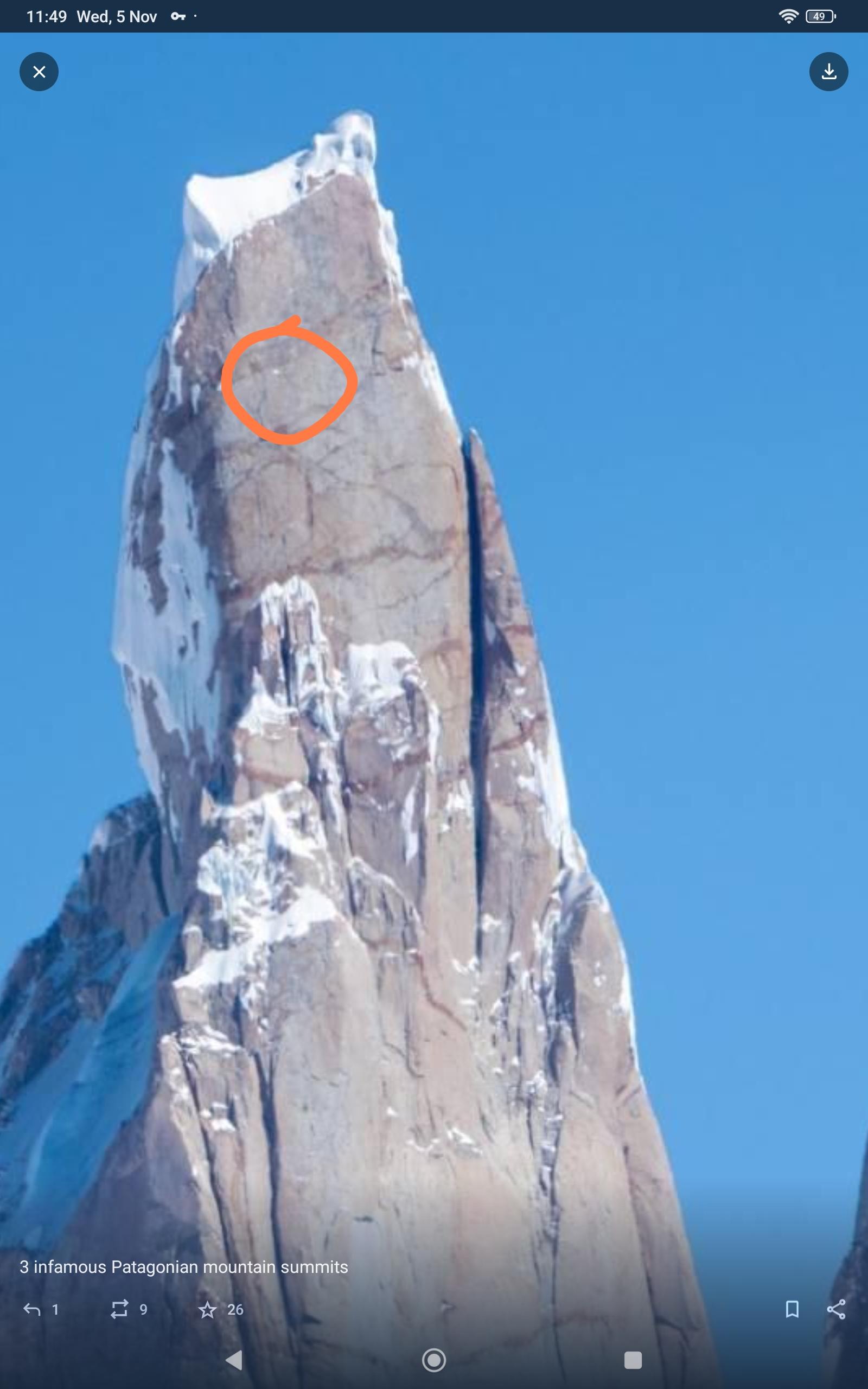 A mountain wall (low res) with an orange circle surrounding a very small snow patch