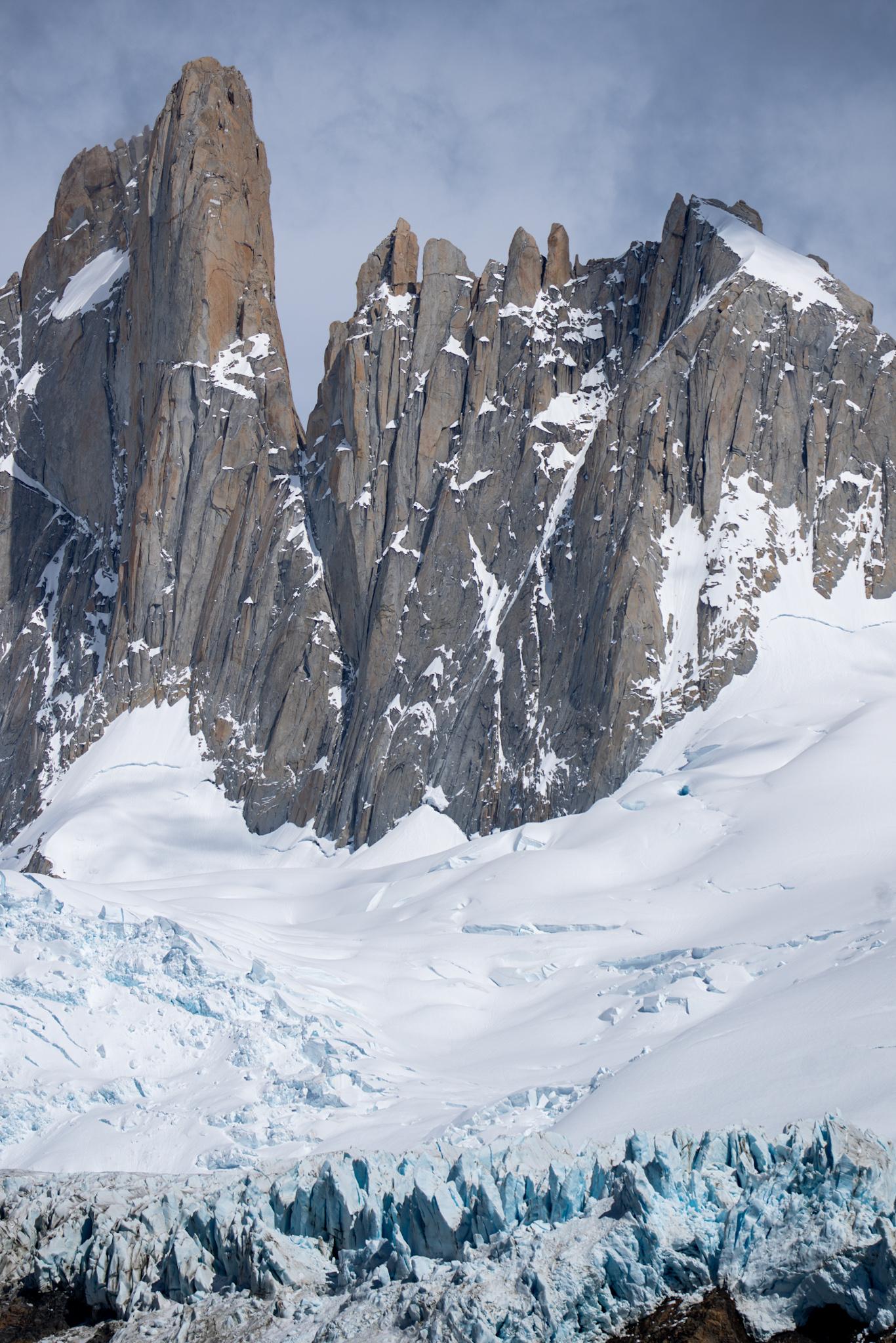 The peaks of Aguja Guillaumet and Aguja Mermoz above the Piedras Blancas glacier. At the foot of the image the glacier breaks over a cliff forming blue ice pinnacles