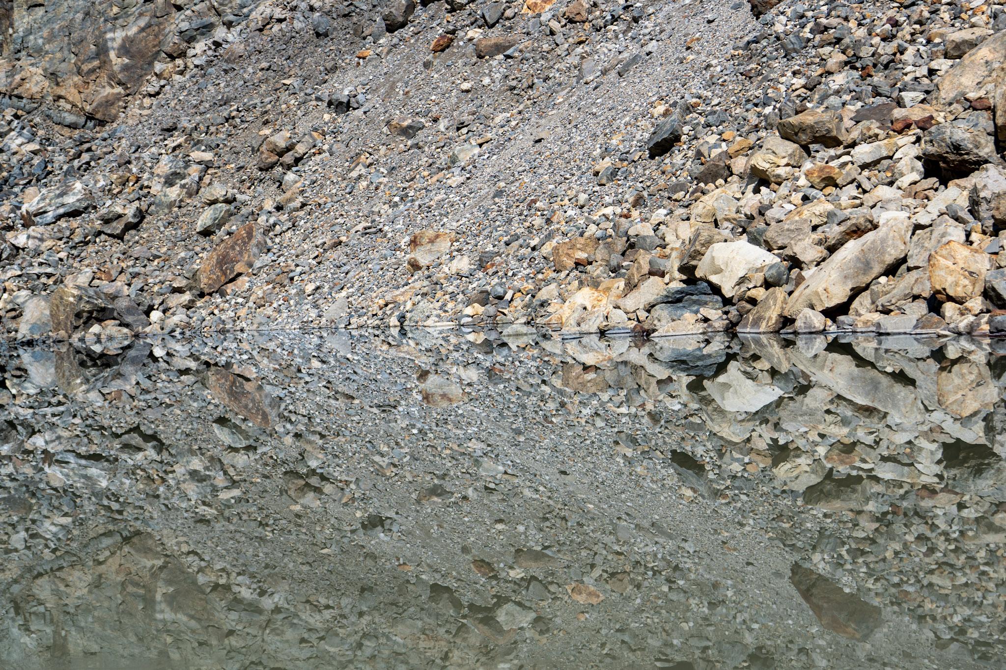 Almost a perfect reflection of the rocks above Laguna Pollone into Laguna Pollone
