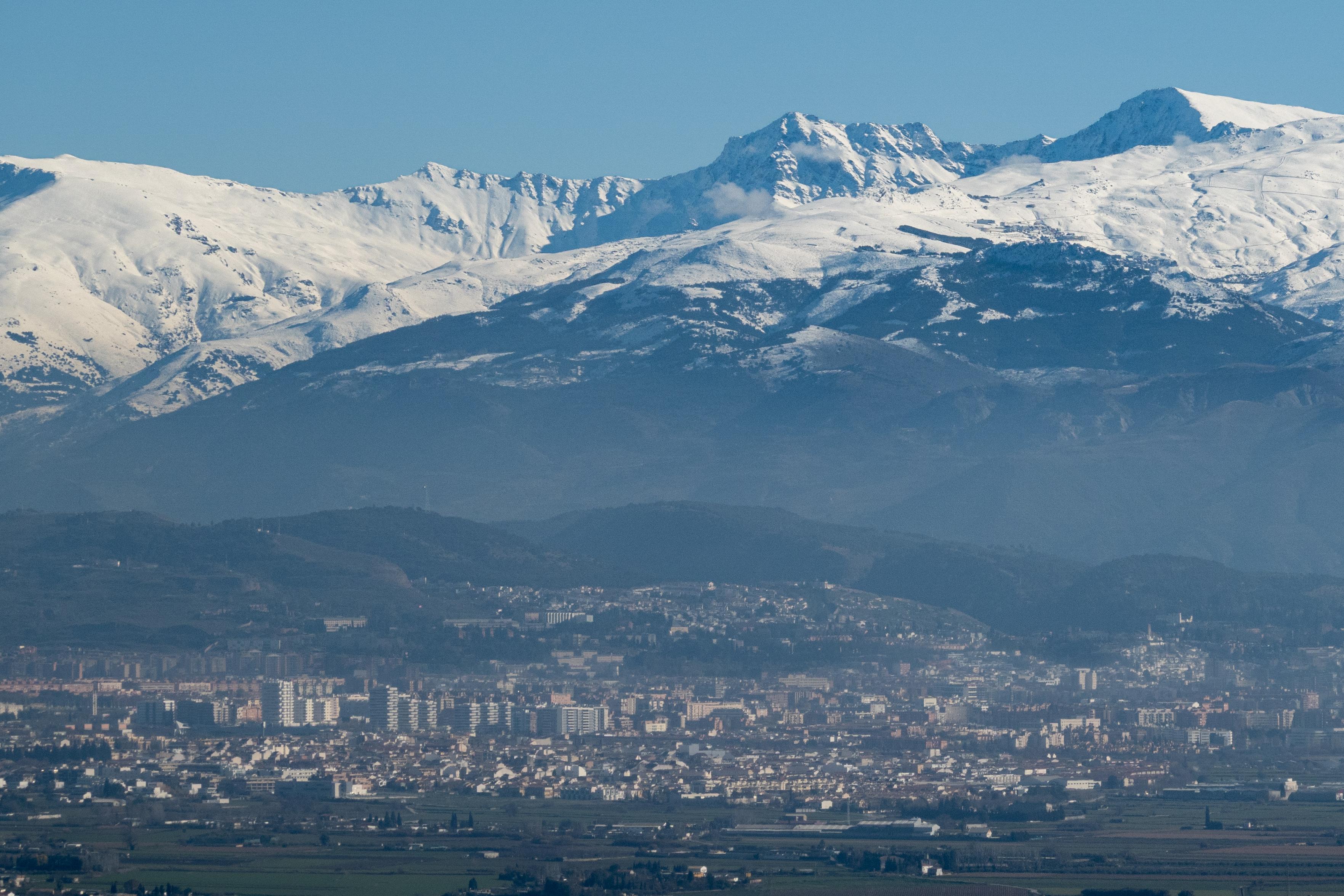 The city of Granada with the snow covered Sierra Nevada mountains rising 3000 metres above