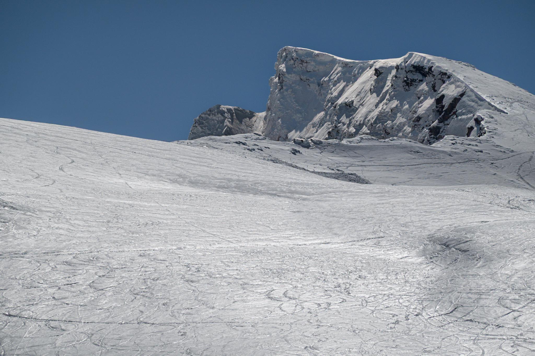 The summit of Veleta mountain rises above the lower snow slopes