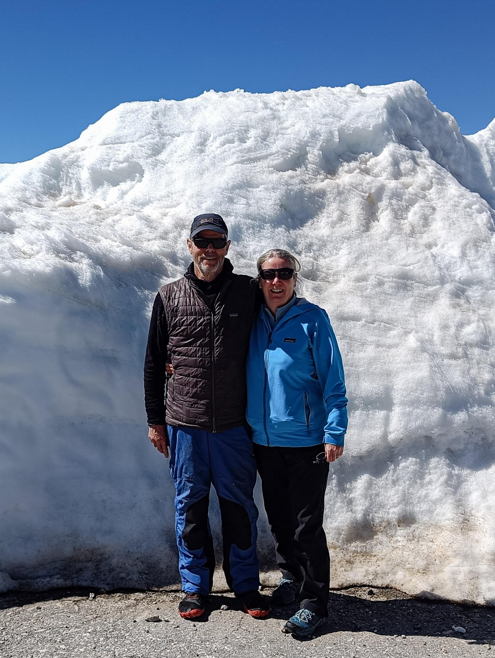 My wife and I standing outside a bar but underneath a large snow bank