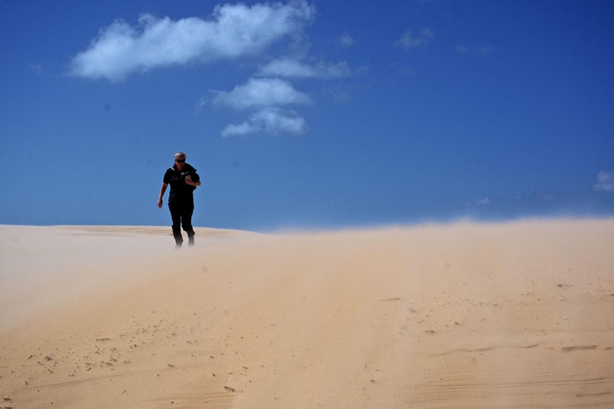 Kiersten struggles back against the strong winds and shifting sands