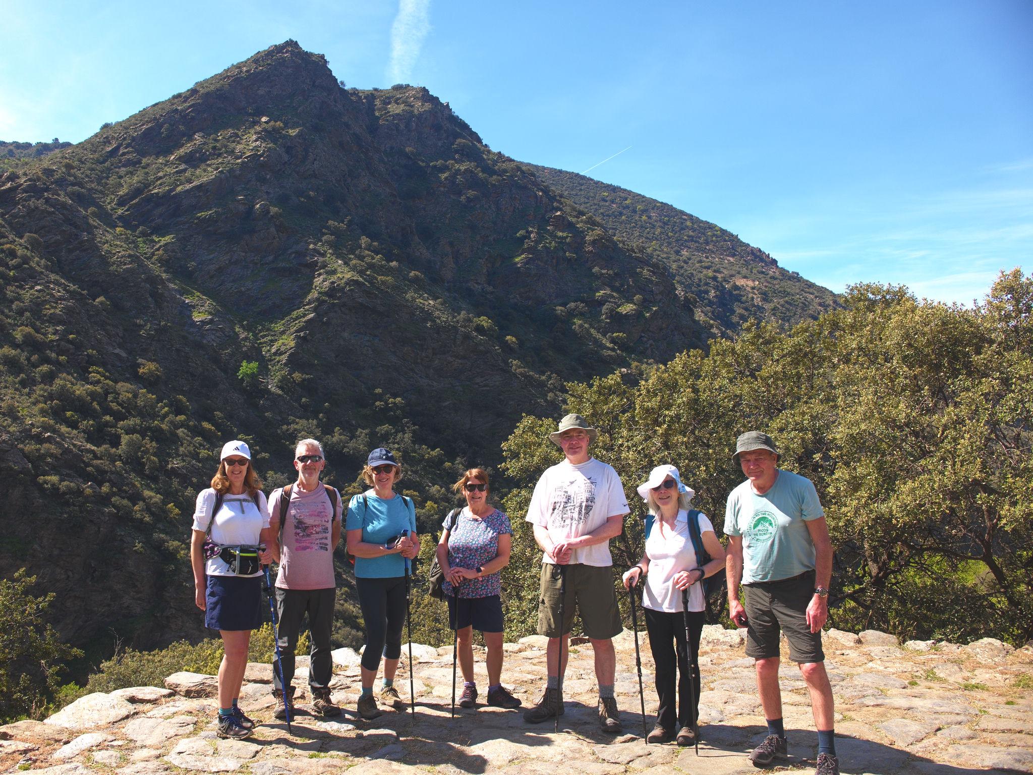 Group stood on an old threshing circle (era) with the deep valley of the Rio Trevelez behind