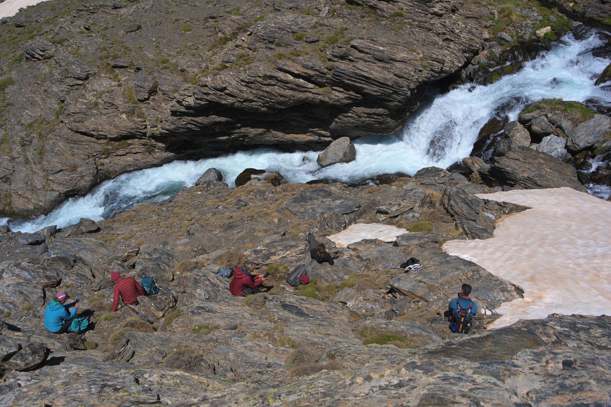 Looking down on my hiking buddies having lunch with the fast flowing Rio Lanjaron river tumbling down the gorge below them